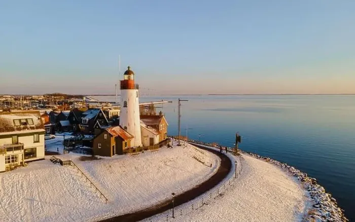 Framed Print : Lighthouse of Urk during winter with snow landscape in the Netherlands. Dutch village in winter Framed Print : Lighthouse of Urk during winter with snow landscape in the Netherlands. Dutch village in winter