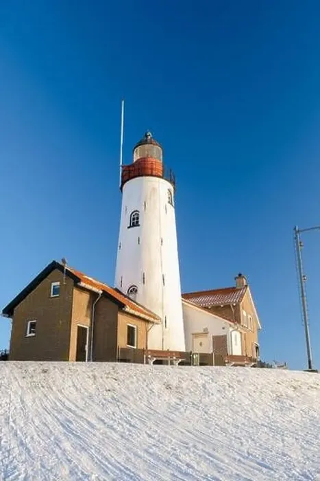Framed Print : Lighthouse of Urk during winter with snow landscape in the Netherlands Framed Print : Lighthouse of Urk during winter with snow landscape in the Netherlands