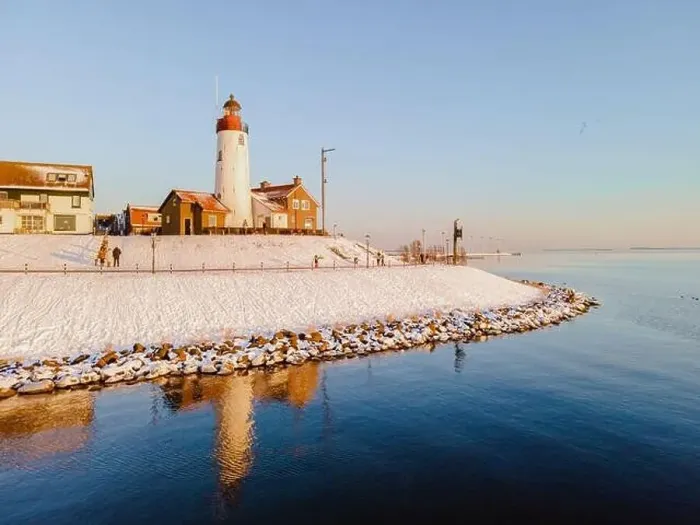 Framed Print : Lighthouse of Urk during winter with snow landscape in the Netherlands at sunset Framed Print : Lighthouse of Urk during winter with snow landscape in the Netherlands at sunset