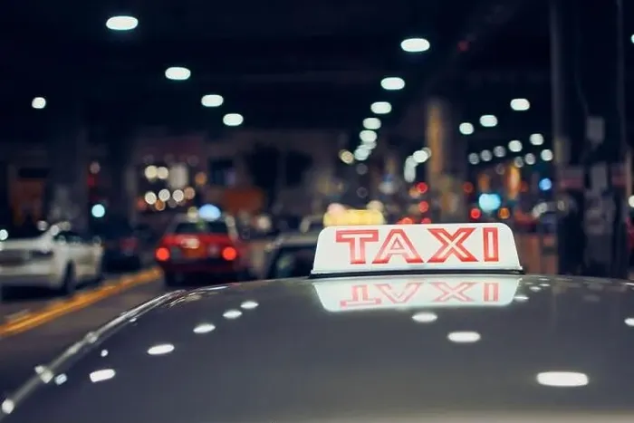 Framed Print : Lighting taxi sign on roof of car on city street at night, Hong Kong Framed Print : Lighting taxi sign on roof of car on city street at night, Hong Kong