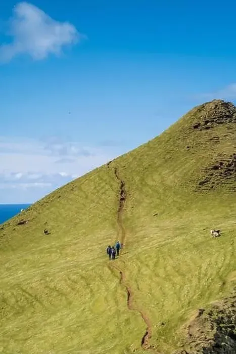 Framed Print : The lime green grass and brilliant blue sky steal the show as these three hikers face a steep incline Framed Print : The lime green grass and brilliant blue sky steal the show as these three hikers face a steep incline