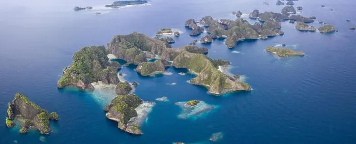 Framed Print : Limestone islands lie scattered about the seascape in Raja Ampat, Indonesia. This remote, tropical region is known for its marine biodiversity Framed Print : Limestone islands lie scattered about the seascape in Raja Ampat, Indonesia. This remote, tropical region is known for its marine biodiversity