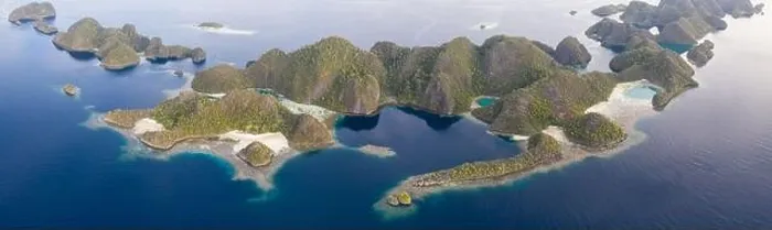 Framed Print : Limestone islands are surrounded by healthy coral reefs in Raja Ampat, Indonesia. This region is thought to be the center of marine biodiversity Framed Print : Limestone islands are surrounded by healthy coral reefs in Raja Ampat, Indonesia. This region is thought to be the center of marine biodiversity