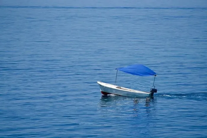 Framed Print : Empty little boat with a blue top on the sea Framed Print : Empty little boat with a blue top on the sea