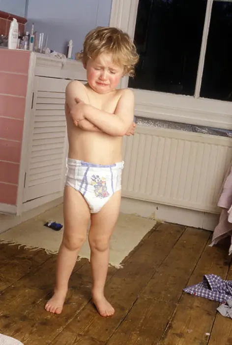 Framed Print : little boy standing in pull-ups in the bathroom looking miserable Framed Print : little boy standing in pull-ups in the bathroom looking miserable