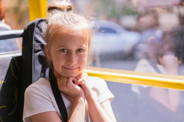 Framed Print : A little girl is going by bus. Schoolgirl sitting in school bus and ready for her first ride Framed Print : A little girl is going by bus. Schoolgirl sitting in school bus and ready for her first ride