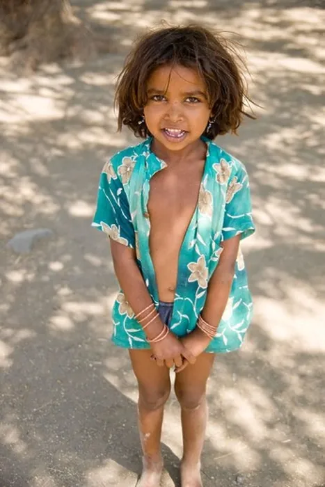Framed Print : A little girl stands in the shade of a tree in a small village near the Ajanta Caves, India Framed Print : A little girl stands in the shade of a tree in a small village near the Ajanta Caves, India