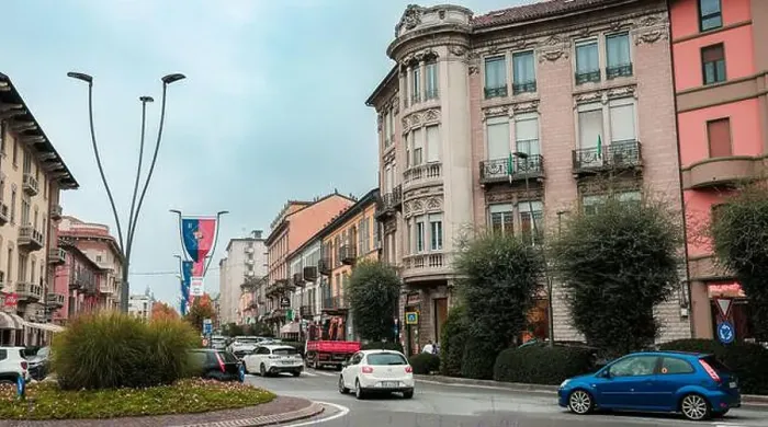 Framed Print : A lively street in Alba Italy shows elegant historic buildings nestled among modern vehicles Framed Print : A lively street in Alba Italy shows elegant historic buildings nestled among modern vehicles