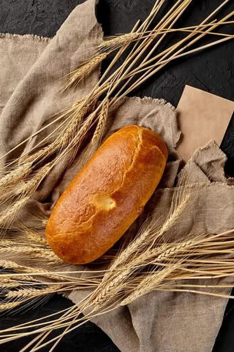Framed Print : Loaf of freshly baked bread on cut of burlap with ears of wheat on black background Framed Print : Loaf of freshly baked bread on cut of burlap with ears of wheat on black background