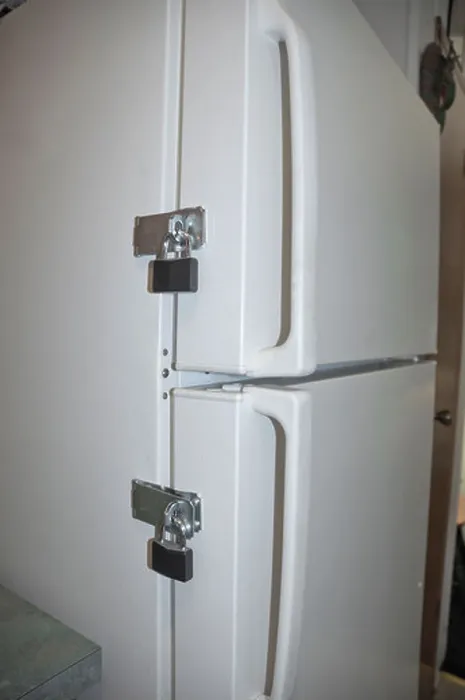 Framed Print : locks on a refrigerator door to keep someone on their diet Framed Print : locks on a refrigerator door to keep someone on their diet
