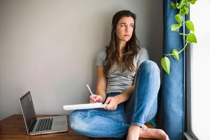 Framed Print : Lonely Individual Woman On her laptop working / studying at home Framed Print : Lonely Individual Woman On her laptop working / studying at home