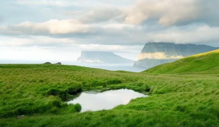 Framed Print : Lonely tourist near small lake looks at foggy islands in Atlantic ocean from Kalsoy island, Faroe Islands, Denmark. Landscape photography Framed Print : Lonely tourist near small lake looks at foggy islands in Atlantic ocean from Kalsoy island, Faroe Islands, Denmark. Landscape photography