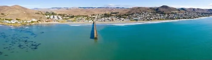 Framed Print : A long pier reaches out into the Pacific Coast in the quaint city of Cayucos, California. This central California region is known for its scenic Framed Print : A long pier reaches out into the Pacific Coast in the quaint city of Cayucos, California. This central California region is known for its scenic