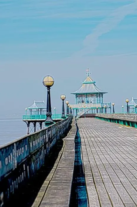 Framed Print : A long wooden pier stretches out into the water Framed Print : A long wooden pier stretches out into the water