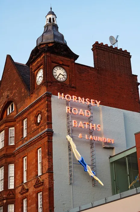 Framed Print : Looking up at a neon sign for the Hornsey Road Baths and Laundry