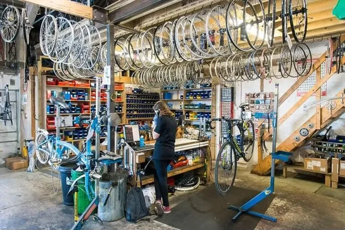 Framed Print : Lots of bike wheels and parts in stock for a cycle repair business hanging from the ceiling Framed Print : Lots of bike wheels and parts in stock for a cycle repair business hanging from the ceiling