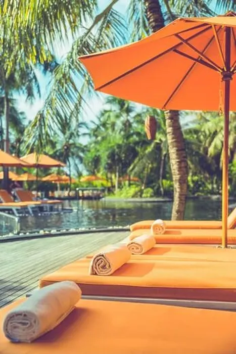 Framed Print : Luxurious resort, tropical poolside, infinity swimming pool with orange loungers and umbrellas under palm trees. Summer vacation, holiday. Spa, fun Framed Print : Luxurious resort, tropical poolside, infinity swimming pool with orange loungers and umbrellas under palm trees. Summer vacation, holiday. Spa, fun
