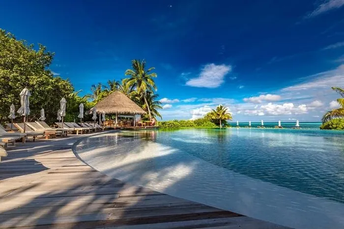 Framed Print : Luxury beach swimming pool at sunset with reflection of palm trees, tropical landscape, exotic island hotel. Loungers and chairs with closed umbrella Framed Print : Luxury beach swimming pool at sunset with reflection of palm trees, tropical landscape, exotic island hotel. Loungers and chairs with closed umbrella