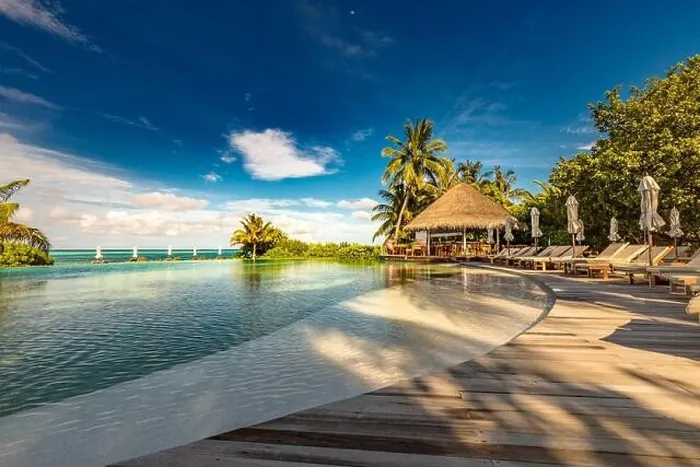 Framed Print : Luxury beach swimming pool at sunset with reflection of palm trees, tropical landscape, exotic island hotel. Loungers and chairs with closed umbrella Framed Print : Luxury beach swimming pool at sunset with reflection of palm trees, tropical landscape, exotic island hotel. Loungers and chairs with closed umbrella