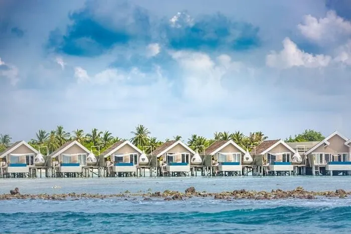 Framed Print : Luxury vacation in Maldives with water bungalows and palm trees background on tropical island. Exotic travel destination Framed Print : Luxury vacation in Maldives with water bungalows and palm trees background on tropical island. Exotic travel destination