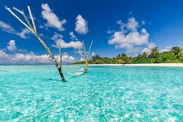 Luxury water hammock in paradise island sea lagoon. Summer beach travel and exotic vacation destination. Inspirational tropical beach travel landscape