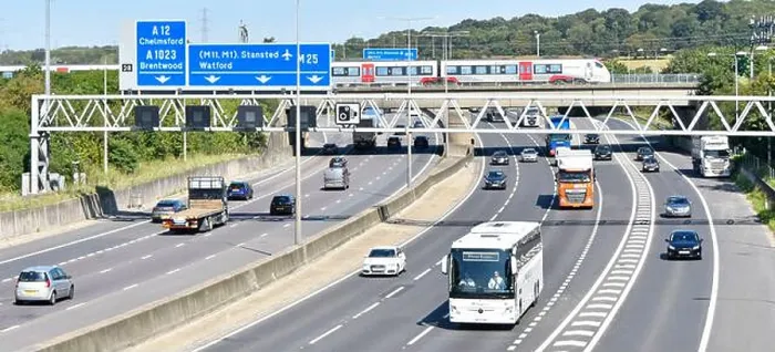 Framed Print : M25 motorway gantry signs railway bridge & Greater Anglia passenger train crossing above road traffic junction 28 for Framed Print : M25 motorway gantry signs railway bridge & Greater Anglia passenger train crossing above road traffic junction 28 for