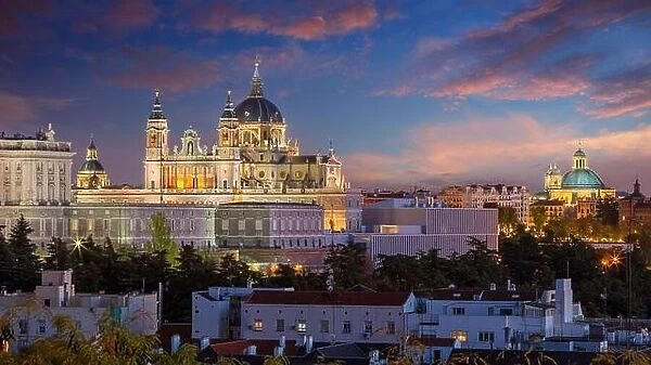 Madrid, Spain. Panoramic cityscape image of Madrid skyline with Santa Maria la Real de La Almudena Cathedral and the Royal Palace at twilight