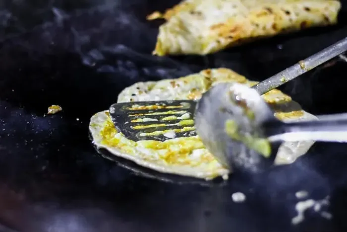 Framed Print : making of egg roll on a hot frying pan with oil and paratha and salad Framed Print : making of egg roll on a hot frying pan with oil and paratha and salad