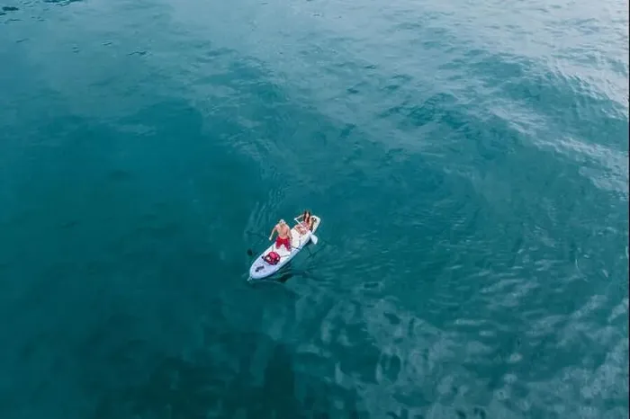 Framed Print : Malcesine, Italy - August 7, 2019: Aerial drone shot view of a man and young girl on surfboard in lake garda Framed Print : Malcesine, Italy - August 7, 2019: Aerial drone shot view of a man and young girl on surfboard in lake garda