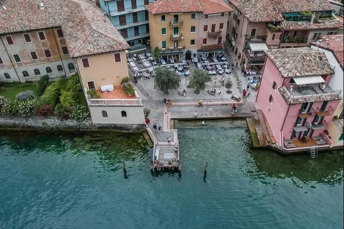 Framed Print : Malcesine, Italy - August 7, 2019: Aerial drone shot of village port in Malcesine Framed Print : Malcesine, Italy - August 7, 2019: Aerial drone shot of village port in Malcesine