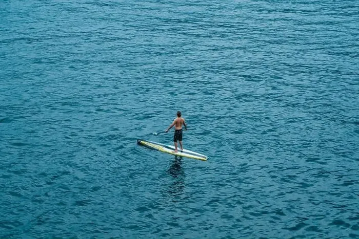 Framed Print : Malcesine, Italy - August 7, 2019: A man on surboard in Lake Garda Framed Print : Malcesine, Italy - August 7, 2019: A man on surboard in Lake Garda