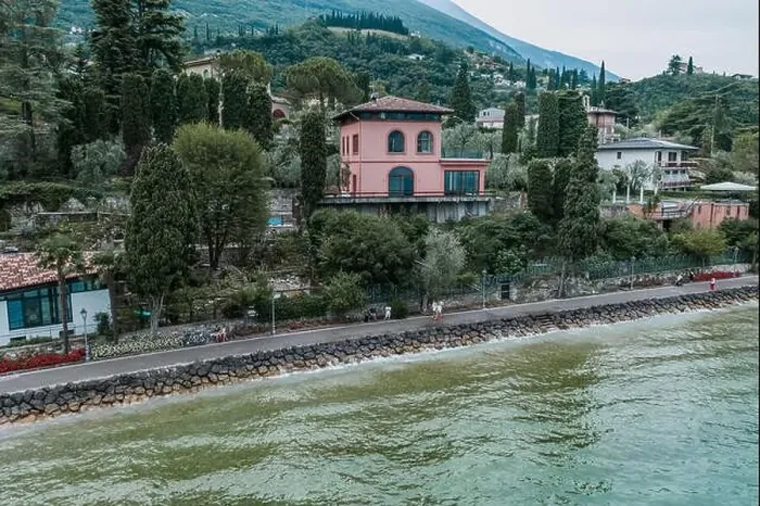 Framed Print : Malcesine, Italy - August 7, 2019: Tourists walk on lakeside of Lake Garda Framed Print : Malcesine, Italy - August 7, 2019: Tourists walk on lakeside of Lake Garda