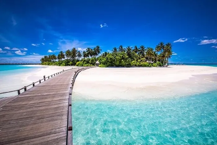 Framed Print : Maldives beach resort panoramic landscape. Tropical vacation beach. Long wooden pier, jetty into paradise island, palm trees, white sand, blue sky Framed Print : Maldives beach resort panoramic landscape. Tropical vacation beach. Long wooden pier, jetty into paradise island, palm trees, white sand, blue sky