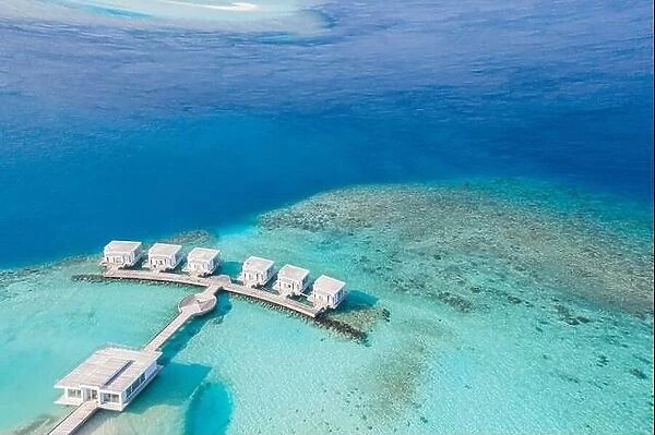 Maldives paradise scenery. top view tropical aerial landscape, seascape with long pier, water villas, amazing sea and lagoon beach, tropical nature
