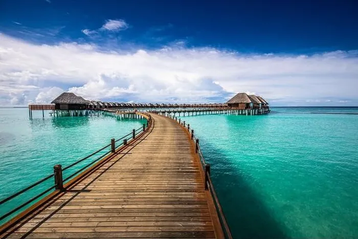 Framed Print : Maldives villa on piles on water, luxury summer travel. Morning sunlight, long wooden jetty under cloudy blue sky. Luxury bungalows, amazing sea Framed Print : Maldives villa on piles on water, luxury summer travel. Morning sunlight, long wooden jetty under cloudy blue sky. Luxury bungalows, amazing sea
