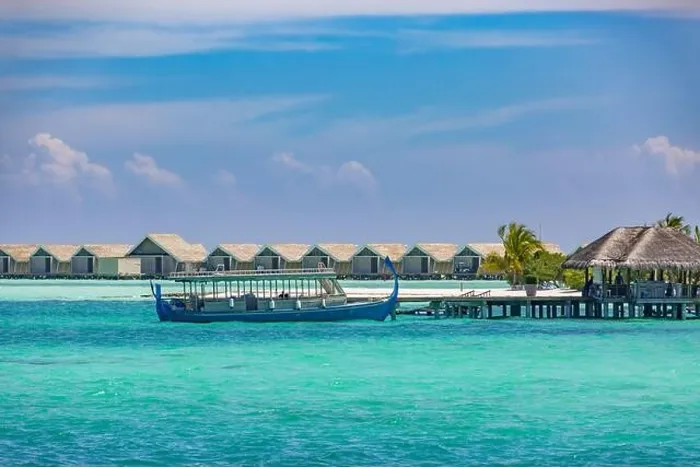 Framed Print : Maldivian water bungalows. Luxury travel background, exotic over water villas, wooden boat Dhoni. Summer travel destination Framed Print : Maldivian water bungalows. Luxury travel background, exotic over water villas, wooden boat Dhoni. Summer travel destination