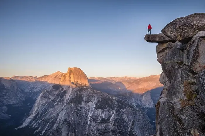 Framed Print : A male hiker standing on an overhanging rock at Glacier Point enjoying the breathtaking view towards famous Half Dome Framed Print : A male hiker standing on an overhanging rock at Glacier Point enjoying the breathtaking view towards famous Half Dome