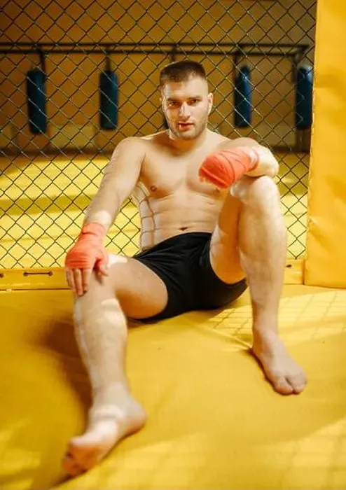 Framed Print : Male MMA fighter sitting on the floor in a cage Framed Print : Male MMA fighter sitting on the floor in a cage