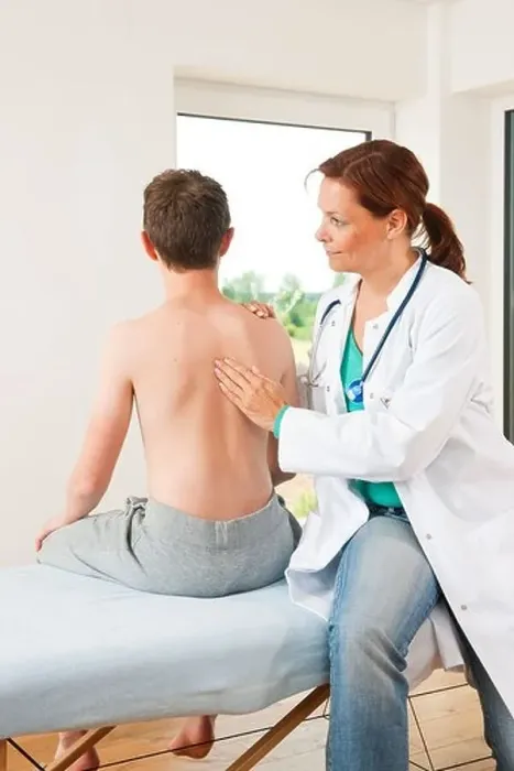 Framed Print : Male teenage boy at female doctor Framed Print : Male teenage boy at female doctor