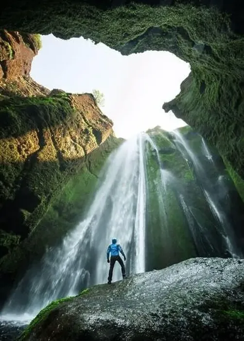 Framed Print : Man in the cave near the Gljufrabui (Gljufrafoss) waterfall Framed Print : Man in the cave near the Gljufrabui (Gljufrafoss) waterfall