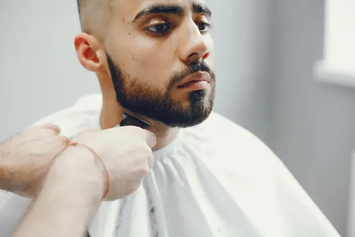 Framed Print : The man cuts his beard in the barbershop Framed Print : The man cuts his beard in the barbershop