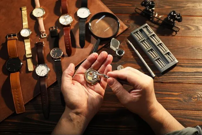 Framed Print : Man fixing mechanism of vintage wrist watch at wooden table, top view Framed Print : Man fixing mechanism of vintage wrist watch at wooden table, top view