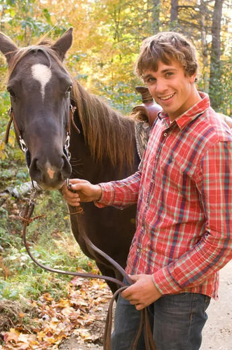 Framed Print : Man holding horse by the reins Framed Print : Man holding horse by the reins