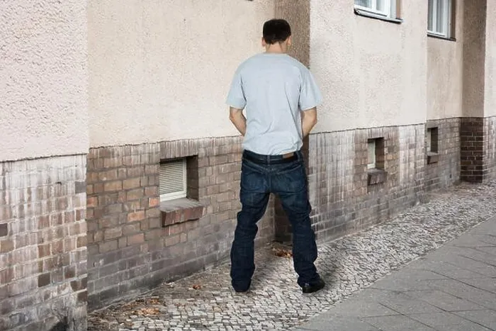 Framed Print : Man Peeing On The Wall Of A Building Framed Print : Man Peeing On The Wall Of A Building