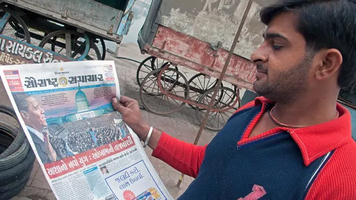 Framed Print : Man reading Gujarati newspaper story of Barack Obama US presidential inauguration Bhavnagar Gujarat India Framed Print : Man reading Gujarati newspaper story of Barack Obama US presidential inauguration Bhavnagar Gujarat India