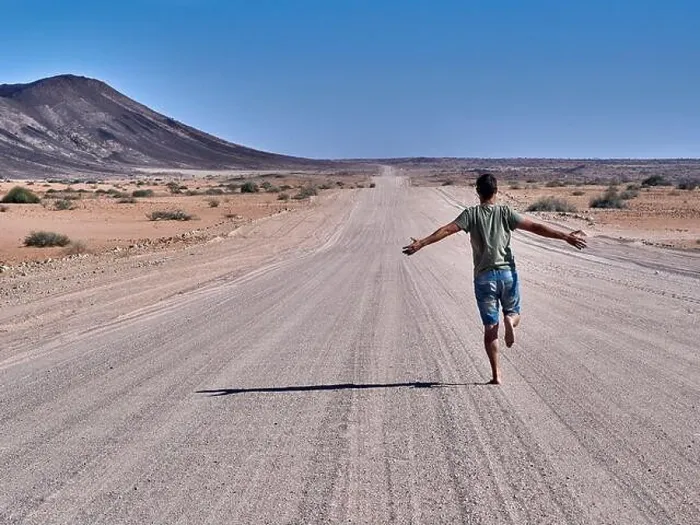 Framed Print : Man running freely on an endless road, rear view, Damaraland, Namibia Framed Print : Man running freely on an endless road, rear view, Damaraland, Namibia