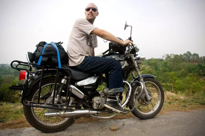 Framed Print : A man sits on a Royal Enfield 'bullet' motorbike during a motorcycle tour in the Himalayas in Himachal Pradesh in India