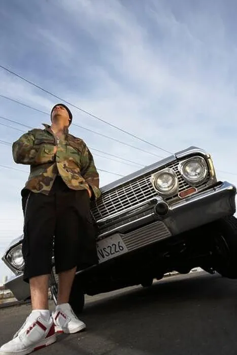 Framed Print : Man standing in front of car low angle view Framed Print : Man standing in front of car low angle view