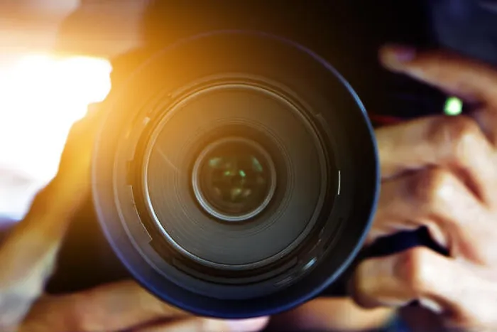 Framed Print : Man using DSLR camera taking photo Framed Print : Man using DSLR camera taking photo