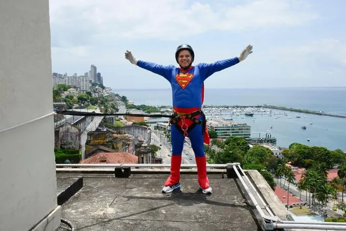 Framed Print : Man wearing black helmet and wearing a hero costume preparing to descend the Lacerda Elevator from Rappel